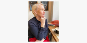 Portrait photo of Sarah Hussey looking out of a window.